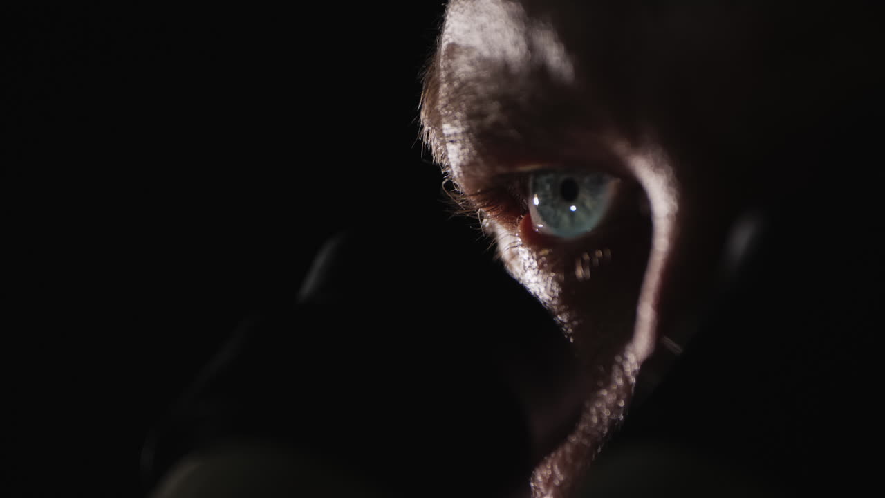 los ojos del investigador miran el ocular del microscopio en la oscuridad