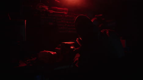person in protective gear in a dark room