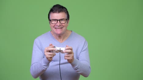 senior handsome man playing games