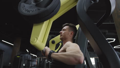 bodybuilding man training in sport club. fitness man bodybuilder training during weightlifting exercise