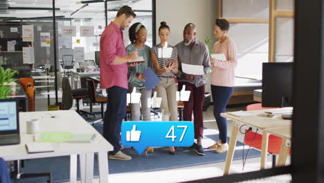 social media likes animation over diverse business team collaborating in office