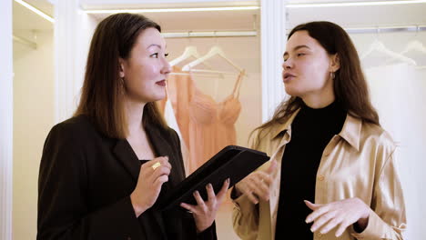 Asian-and-caucasian-woman-in-wedding-dress-shop