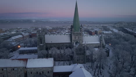 Aerial-View-Of-Nidaros-Cathedral-During-Winter-In-Trondheim,-Norway---drone-shot