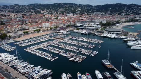 drone flying over boats and yachts moored in marina on french riviera