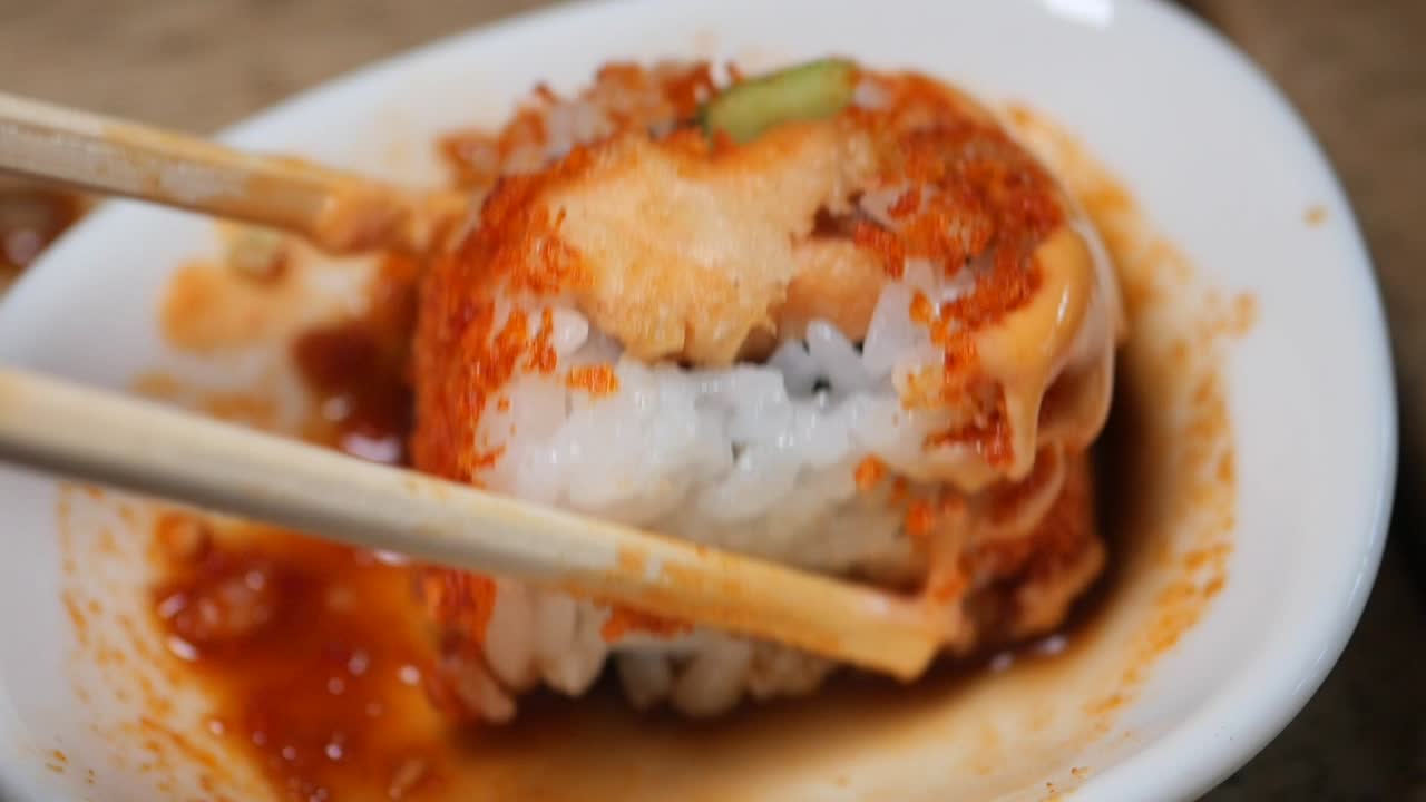 Sushi roll with chopsticks