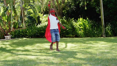 little boy running in costume of superhero