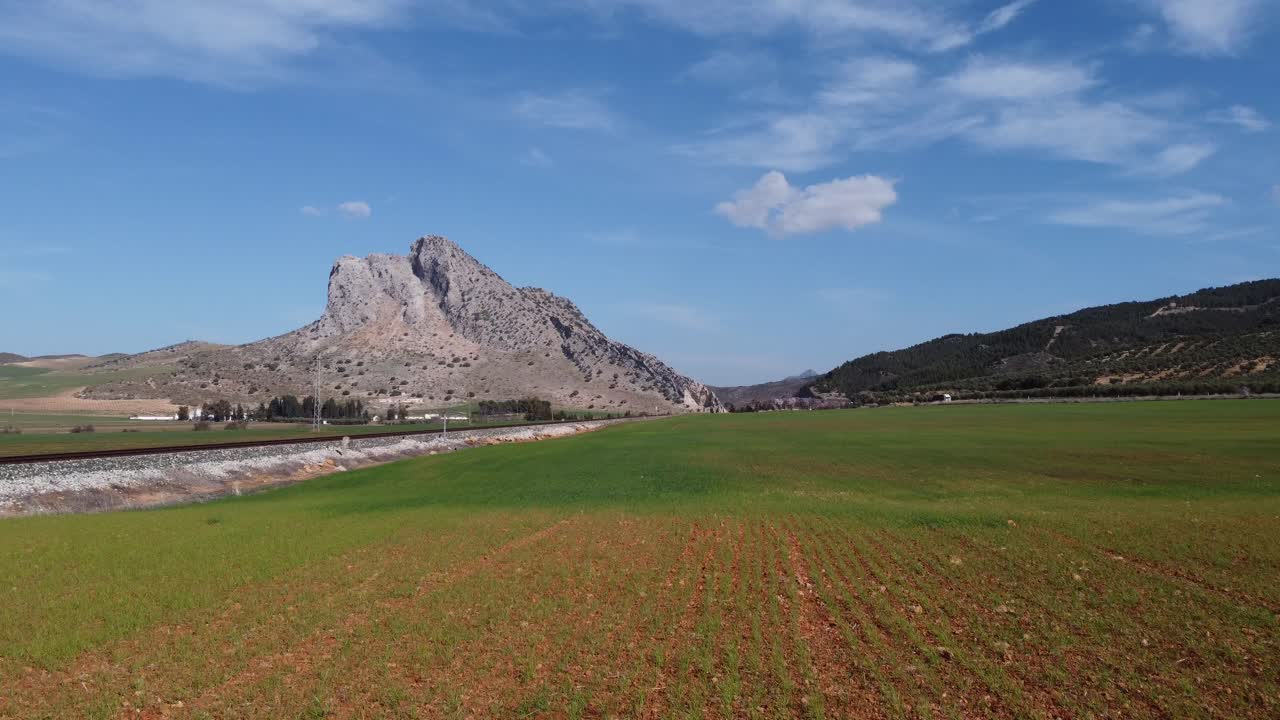 Spectacular aerial flight over the enclave of Pe&ntilde;a de los Enamorados, a rock formation in the shape of a human face in the municipality of Antequera in Andalusia, Spain