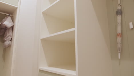 modern white wardrobe with shelves and drawers