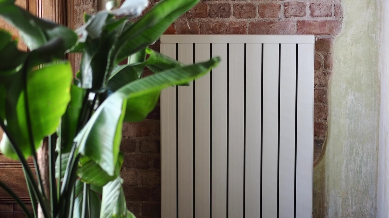 Modern White Radiator Against Exposed Brick Wall with Houseplant