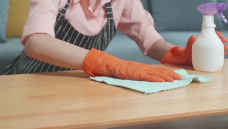 woman cleaning a table