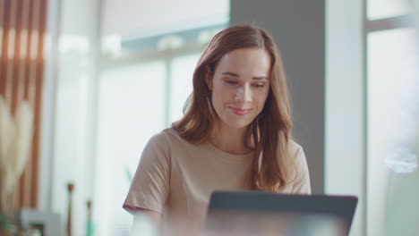 Woman-typing-message-on-laptop