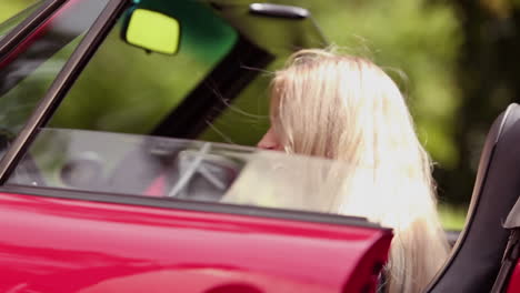 Happy-woman-sitting-in-her-car-