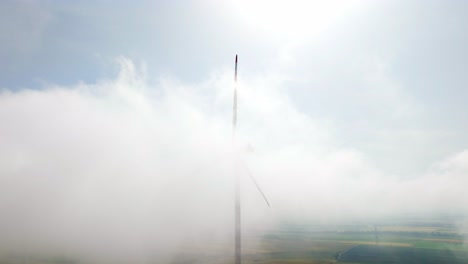 wind turbine in foggy weather in weinviertel, austria - drone shot