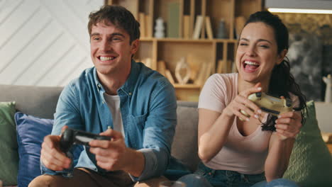 family enjoy video game laughing giving five at home close up. happy gamers