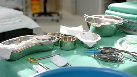 close up of surgical instruments on table in operating theatre at hospital, slow motion