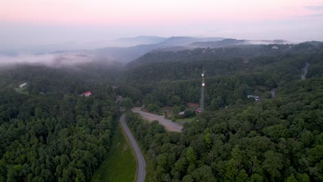 aerial orbit of communications tower with microwave dishes near boone nc, north carolina