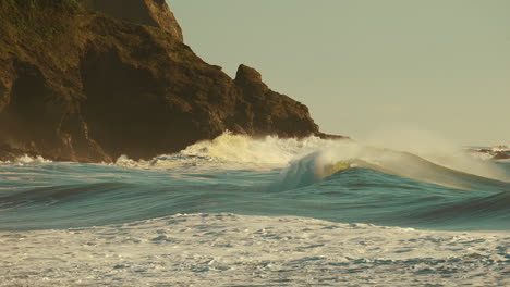 ocean waves raging over the rocky shore on a windy sunny morning