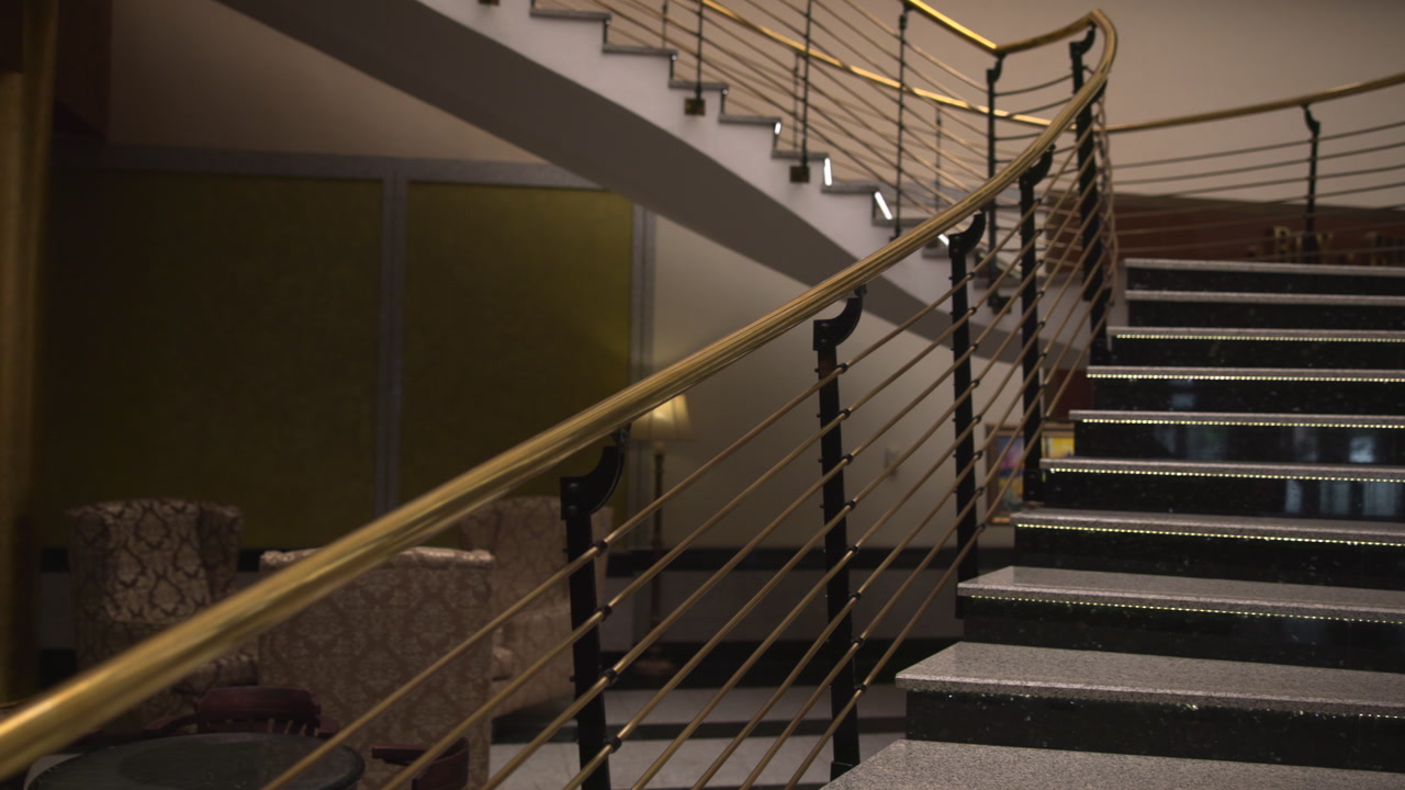 Brass Handrail Curved Staircase Hotel Lobby, Empty Evening Scene With Marble Steps And LED Riser Lights, Warm . Media