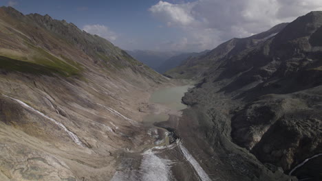 Retreating-glacier-due-to-global-warming,-Austrian-longest-and-fastest-melting-glacier-Pasterze-at-the-foot-of-the-Grossglockner-Mountain,-Aerial-View