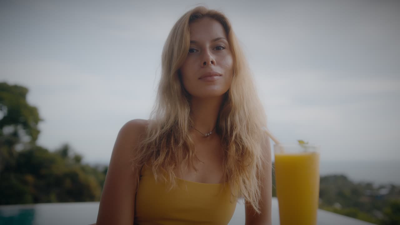 Woman enjoying a smoothie by the pool