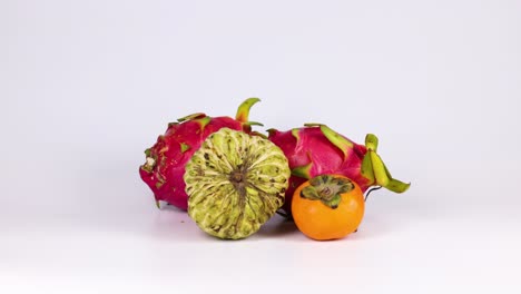 hands picking and arranging various colorful fruits