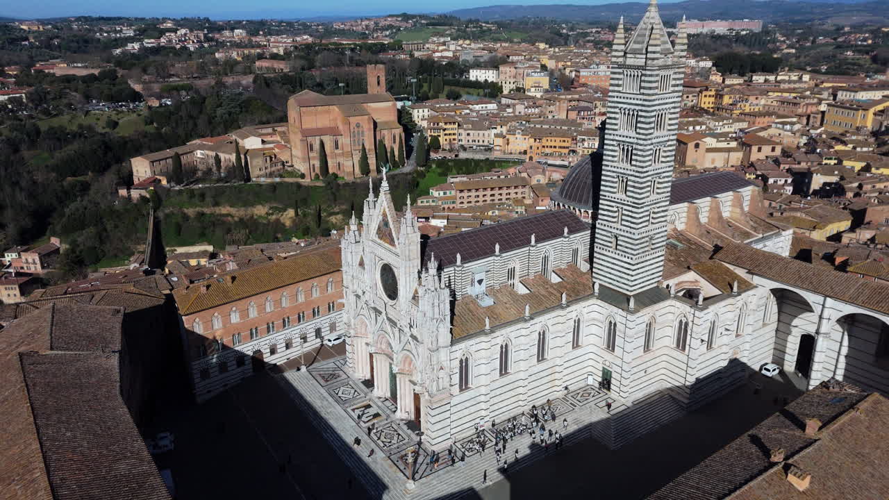 panoramic drone shot of siena’s iconic duomo and cityscape