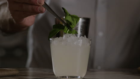 Garnishing-a-margarita-with-basil