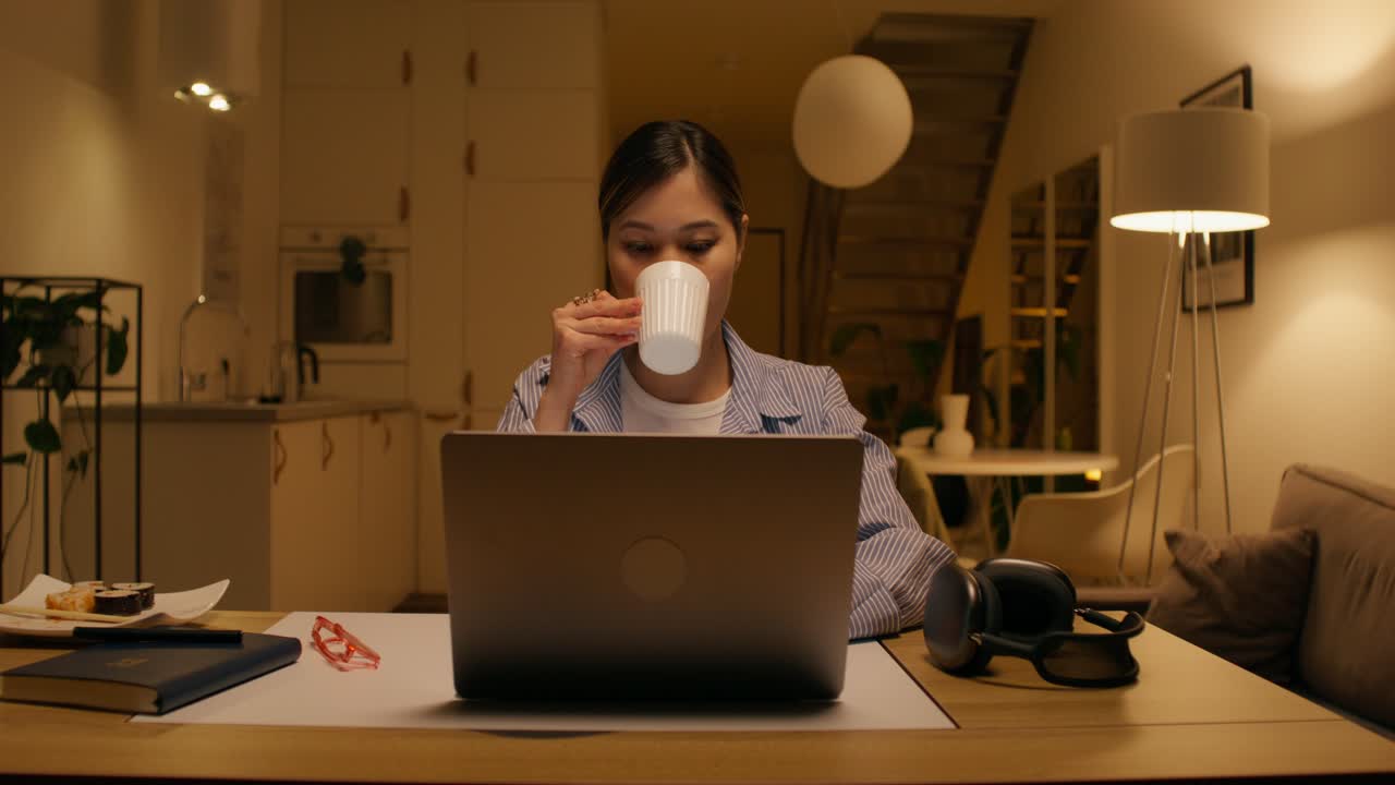 Woman working from home at night
