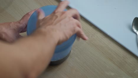 closing plastic container lid full of soy sauce marinade for storage. -closeup shot