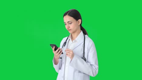 Indian-female-doctor-using-phone-Green-screen