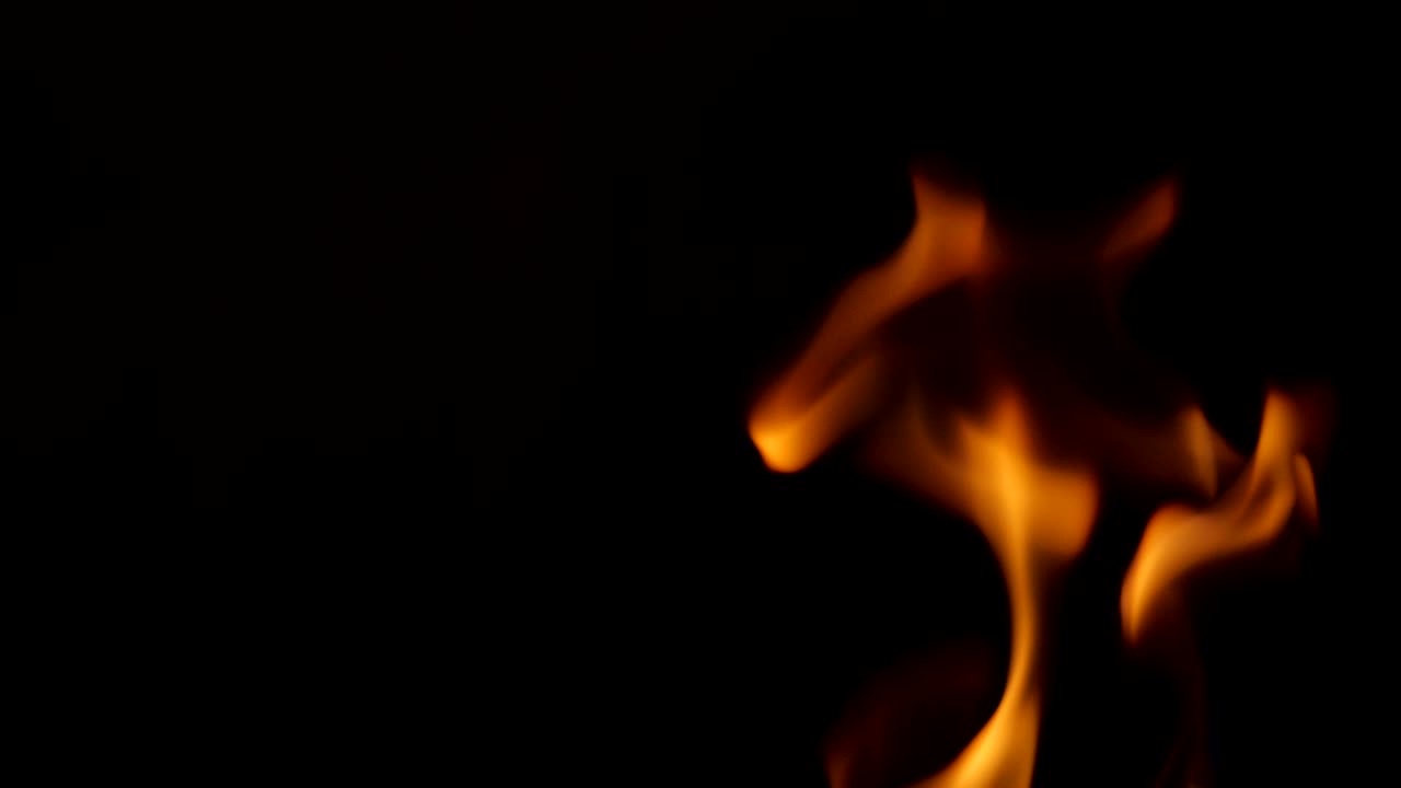 Sparkling and flying up vertical sparkles for using in composition,  . Screen mode for blending or transitions. Bright flames of fire over black studio background isolated, slow motion 200 fps