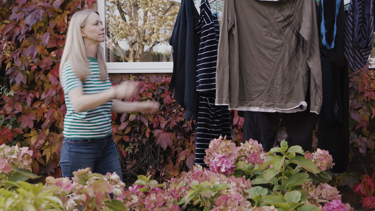 Woman Hanging Clothes on Clothesline
