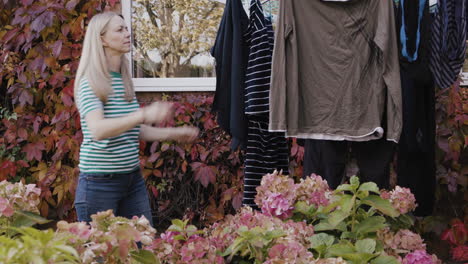 woman hanging clothes on clothesline