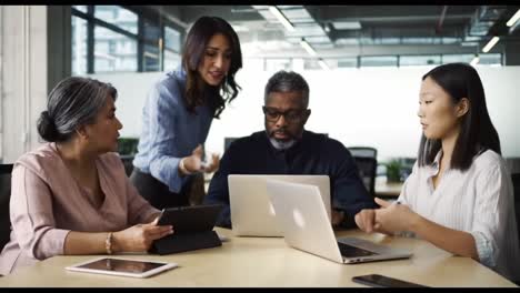 engaged team collaboration: a diverse group of professionals interacting in a modern office setting while utilizing technology to discuss ideas and strategies
