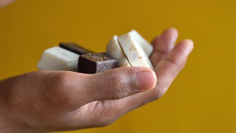 Child-hand-pick-dark-chocolate-,