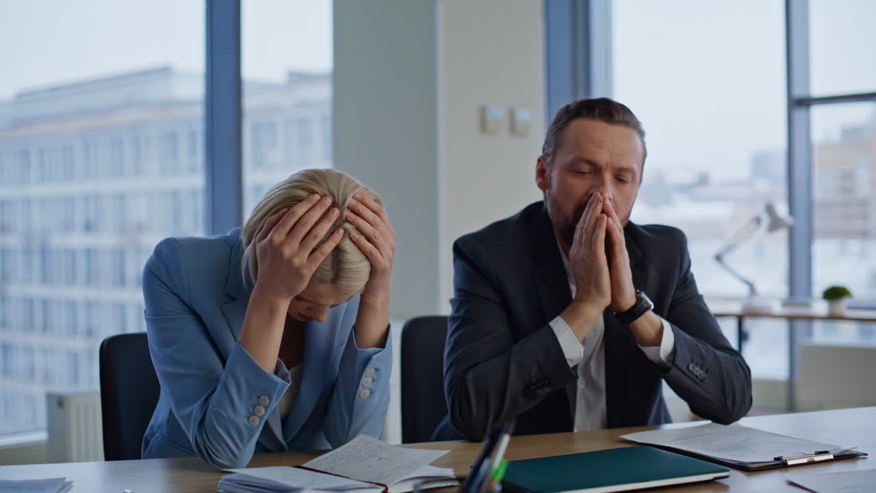 Troubled colleagues frustrated fail working together at light office closeup