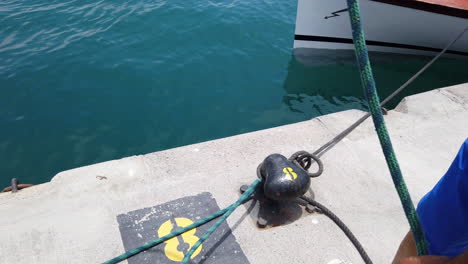 sailor-man-prepares-a-sailor-knot-to-place-it-on-the-mooring-bollard