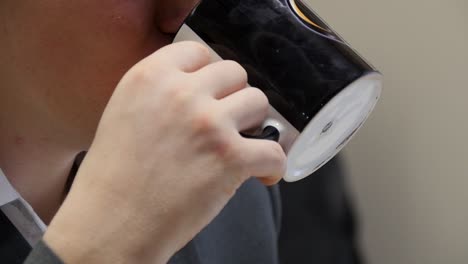 person drinking from mug