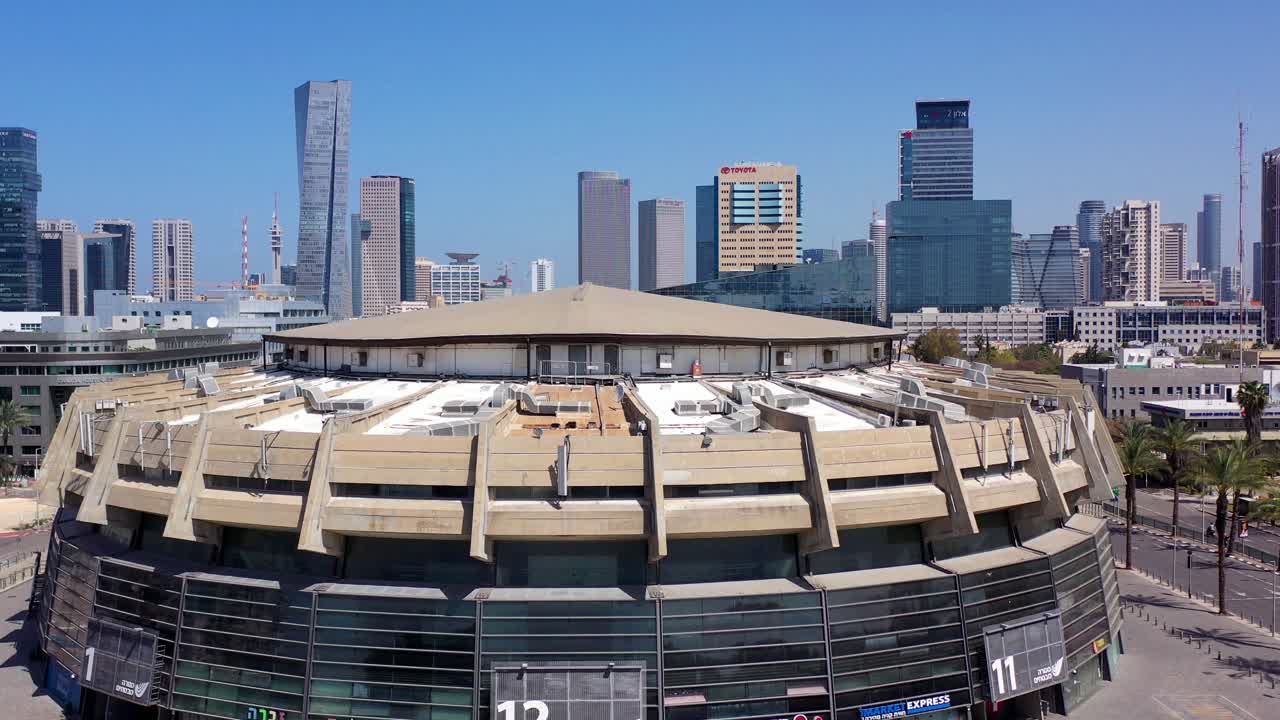 Tel Aviv Expo building with city skyline on a clear day