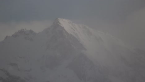 4k timelapse of clouds moving through the snowy rocky mountains