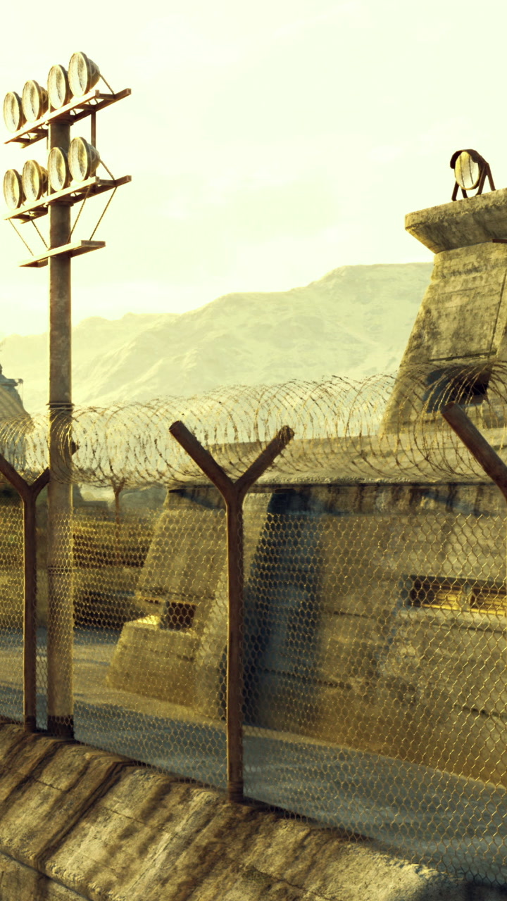 Wires and shadows at a distant border post during a golden hour