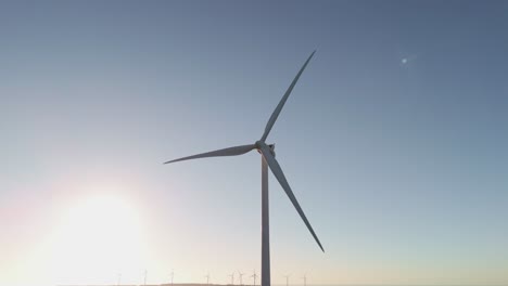 Rotating-Wind-Turbines-Over-Mountains-In-Portugal-During-Sunset