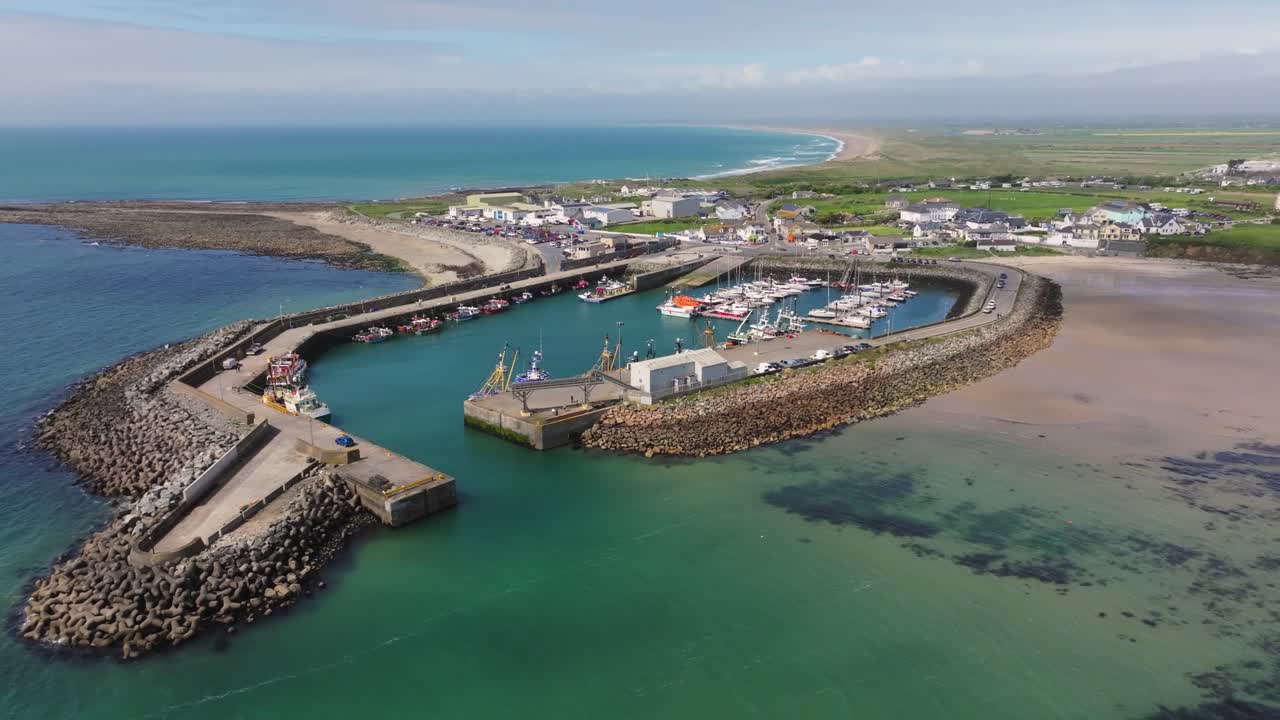 4K cinematic drone footage capturing Kilmore Quay, on a bright day, showcasing the picturesque harbour, and colourful fishing boats Co.Wexford - Ireland_002
