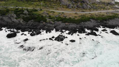 White-Foamy-Waves-On-Rocky-Shore-Of-Matakitaki-a-kupe-Reserve-Along-Cape-Palliser-Road-In-North-Island-Of-New-Zealand