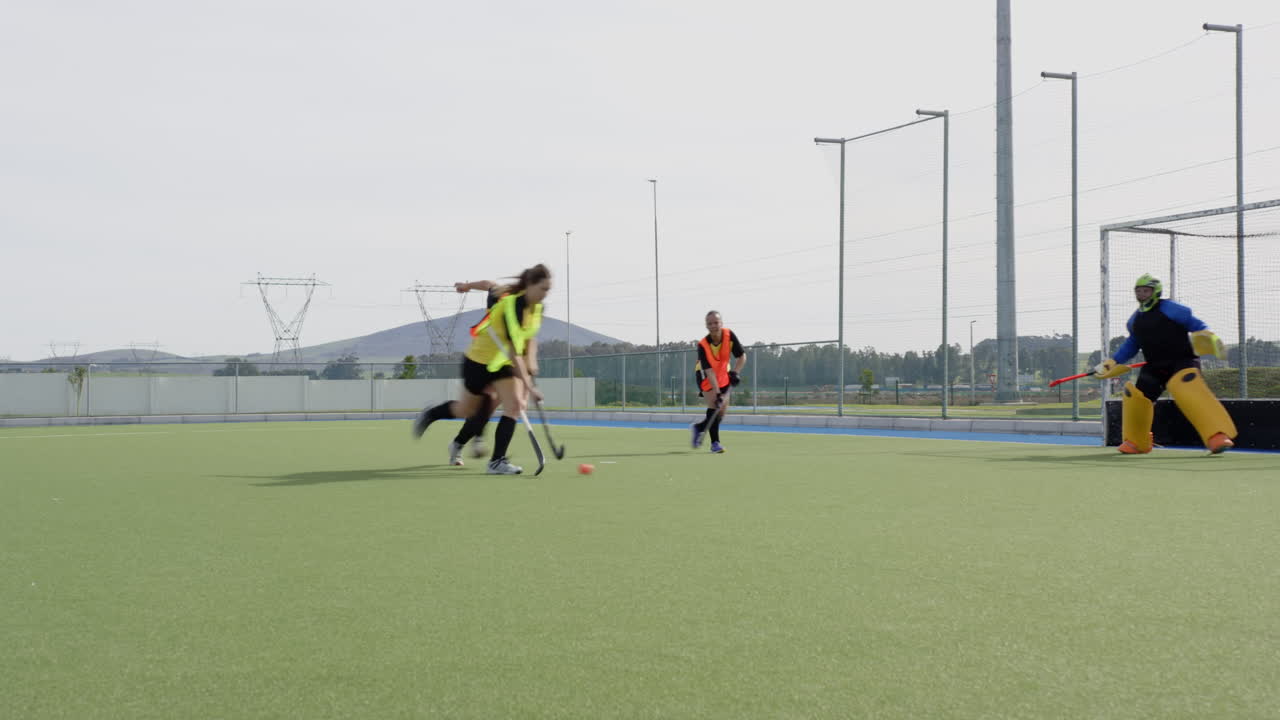 Competing intensely, female hockey players focusing on teamwork and strategy on field