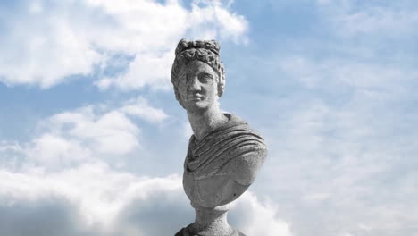 Animation-of-gray-sculpture-of-man-over-blue-sky-and-clouds