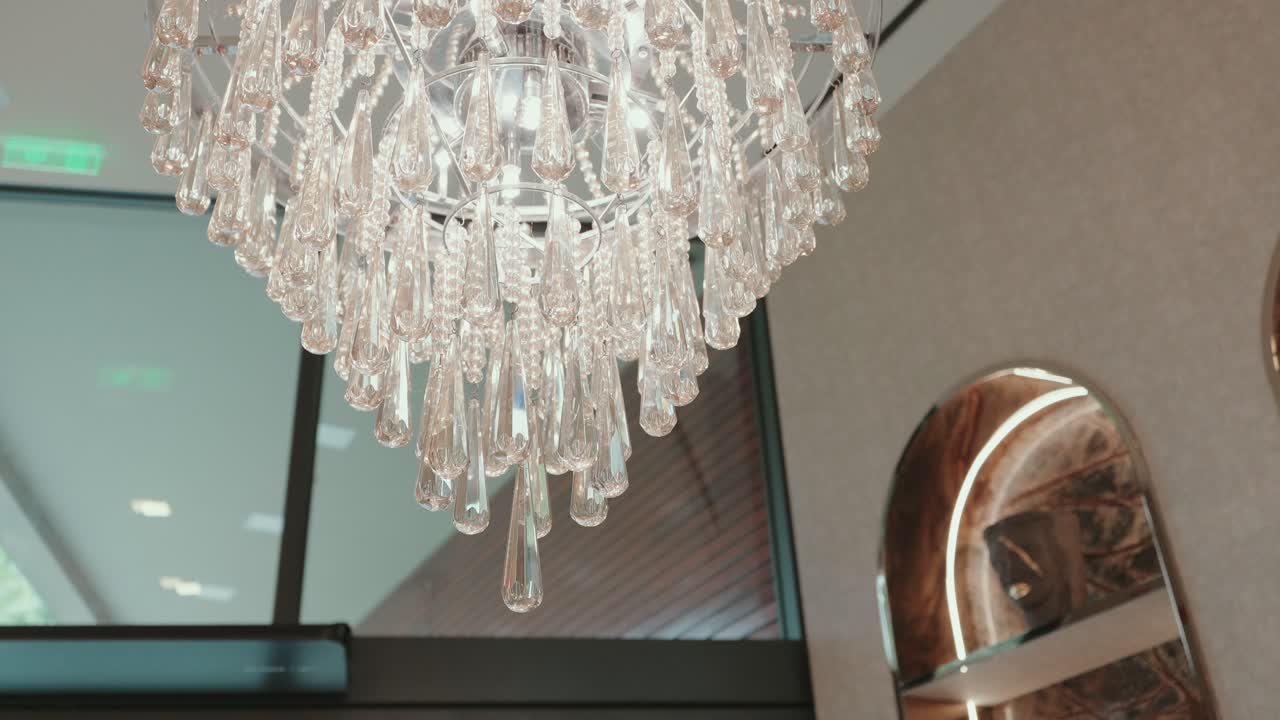 close up of crystal chandelier with teardrop pendants in a refined contemporary room