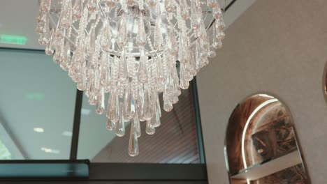 close up of crystal chandelier with teardrop pendants in a refined contemporary room