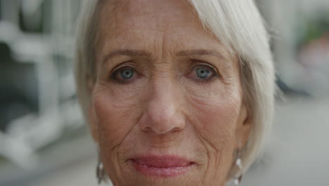 close up portrait of middle aged woman looking at camera thoughtful pensive enjoying retirement in urban city real people series