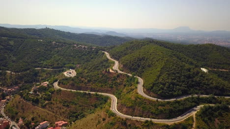 Aerial-shot-of-the-green-mountains-off-the-city-of-Barcelona-Spain